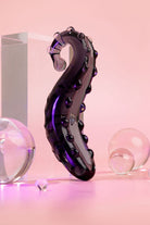 Midnight Black Ink coloured Sacred Squirter. Glass Pleasure wand with ridges pictured with acrylic block and bubbles.